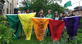 students with AQI flags in front of school